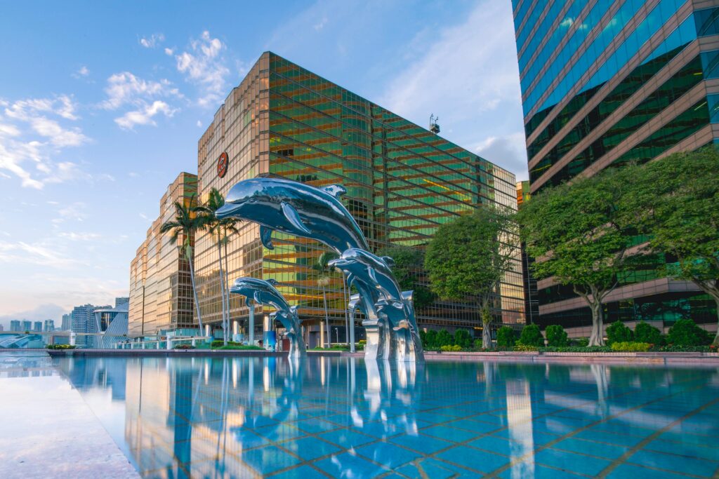 Explore a luxury resort poolside with iconic dolphin statues in Kowloon, Hong Kong.