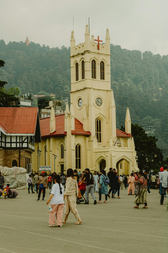 Bustling scene at Christ Church, Shimla, India showcasing local architecture and culture.