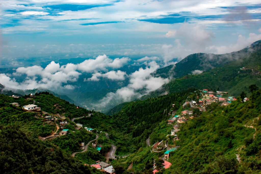 Captivating view of lush mountains and clouds in Mussoorie, India, showcasing natural beauty.